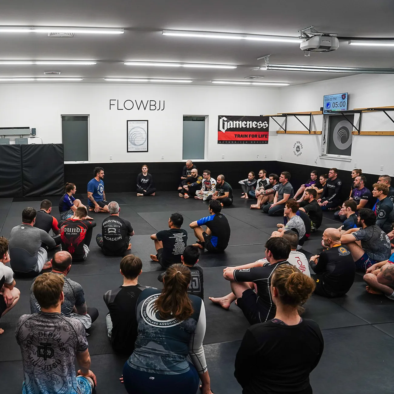 Adult Brazilian Jiu Jitsu class training on the mats at Flow BJJ in Rockland, Maine