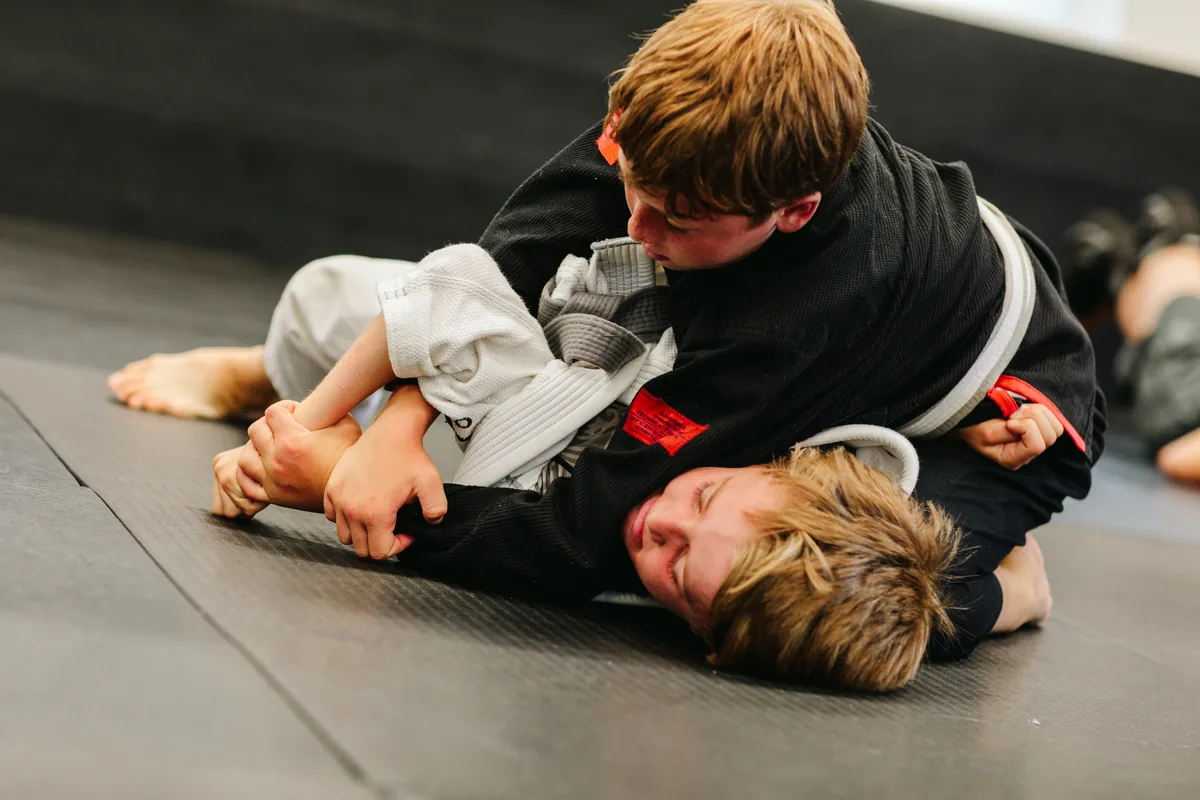 Kids drilling a submission during BJJ training