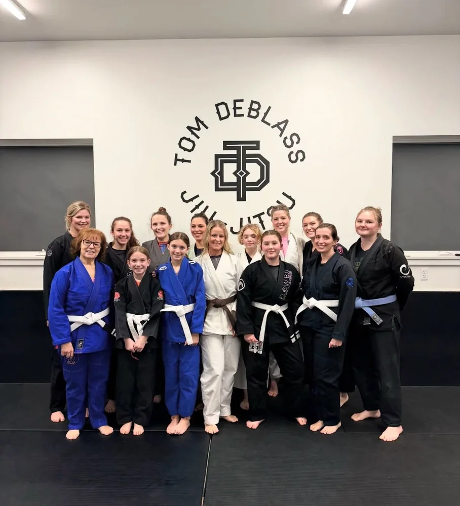 Women of all ages with Coach Sandy after women's Jiu Jitsu class at Flow BJJ