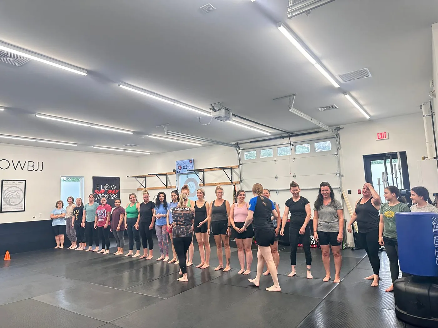 Women lined up on the mats during women's class at Flow BJJ